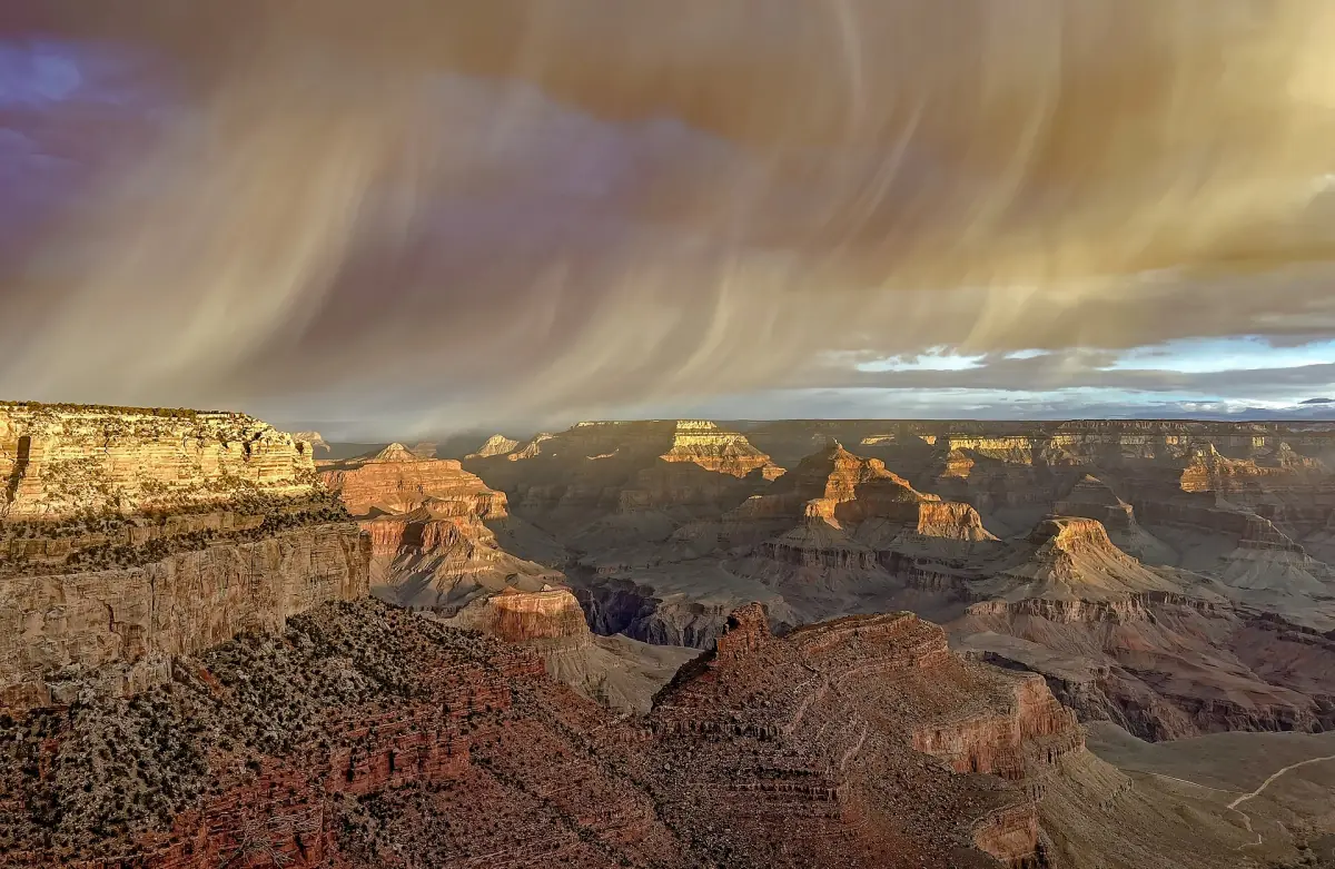 Snow clouds moving across the canyon at sunrise